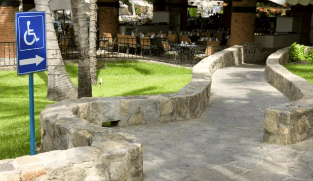 An accessible ramp with sign at a restaurant.